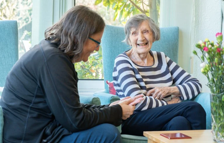 Staff Member And Resident Enjoying Time Together