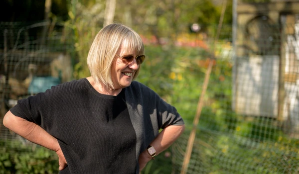 Smiling Older Woman Standing In Allotment