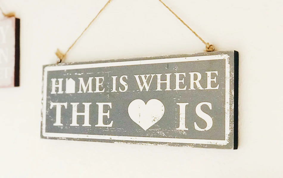 Sign on the wall saying Home is the where the heart is