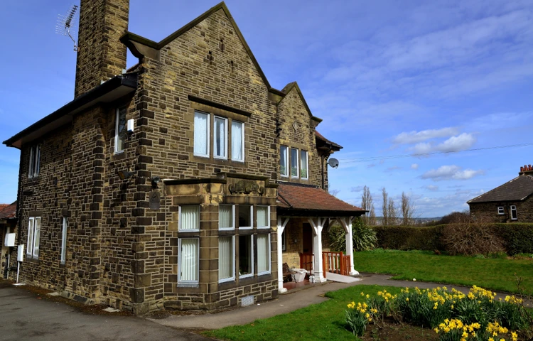 Beautiful large house with a bed of daffodils to the front of Leylands Lane, Bradford BD9 5QU