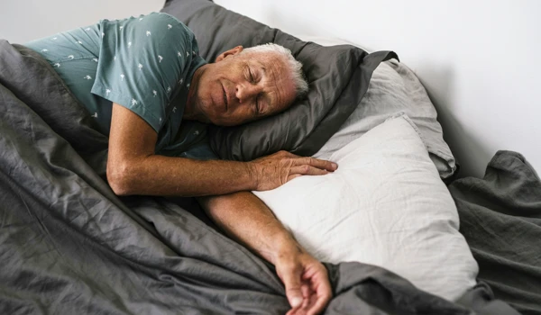 Older Man Asleep In Bed