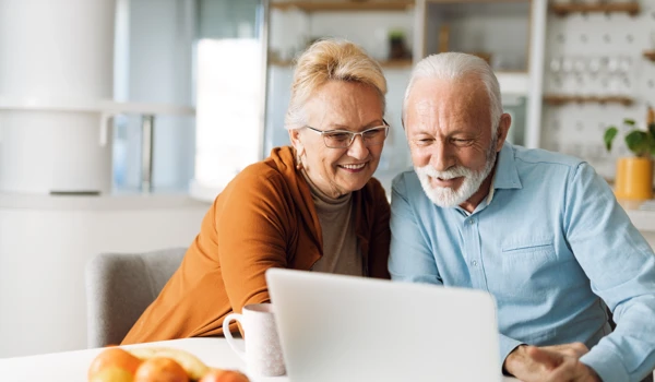 Older Couple Looking At Laptop