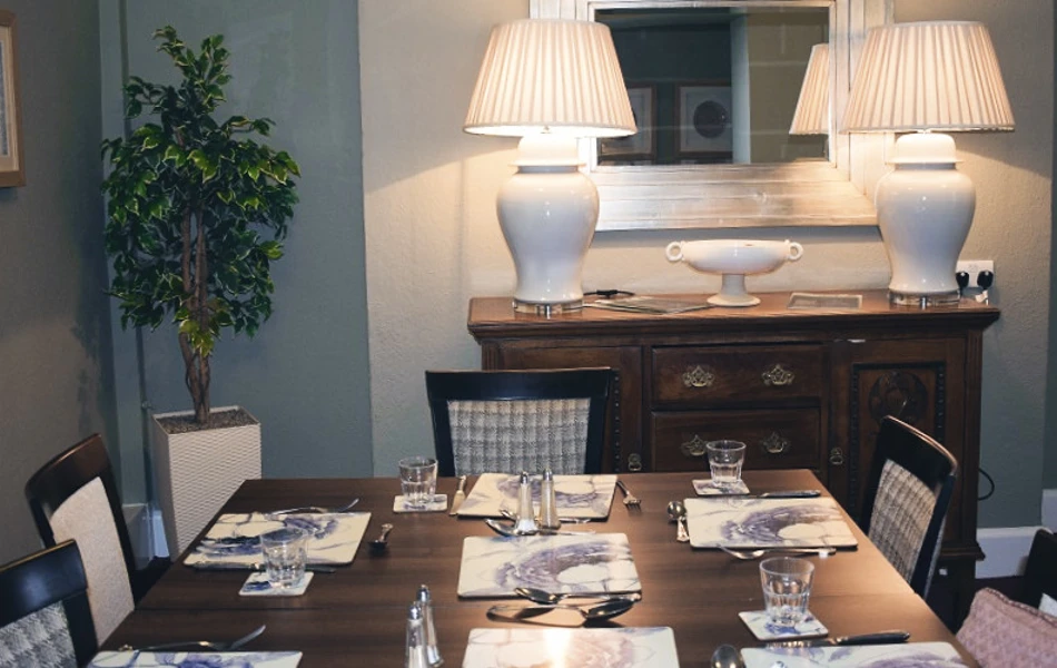 Mahogany dining table set for dinner