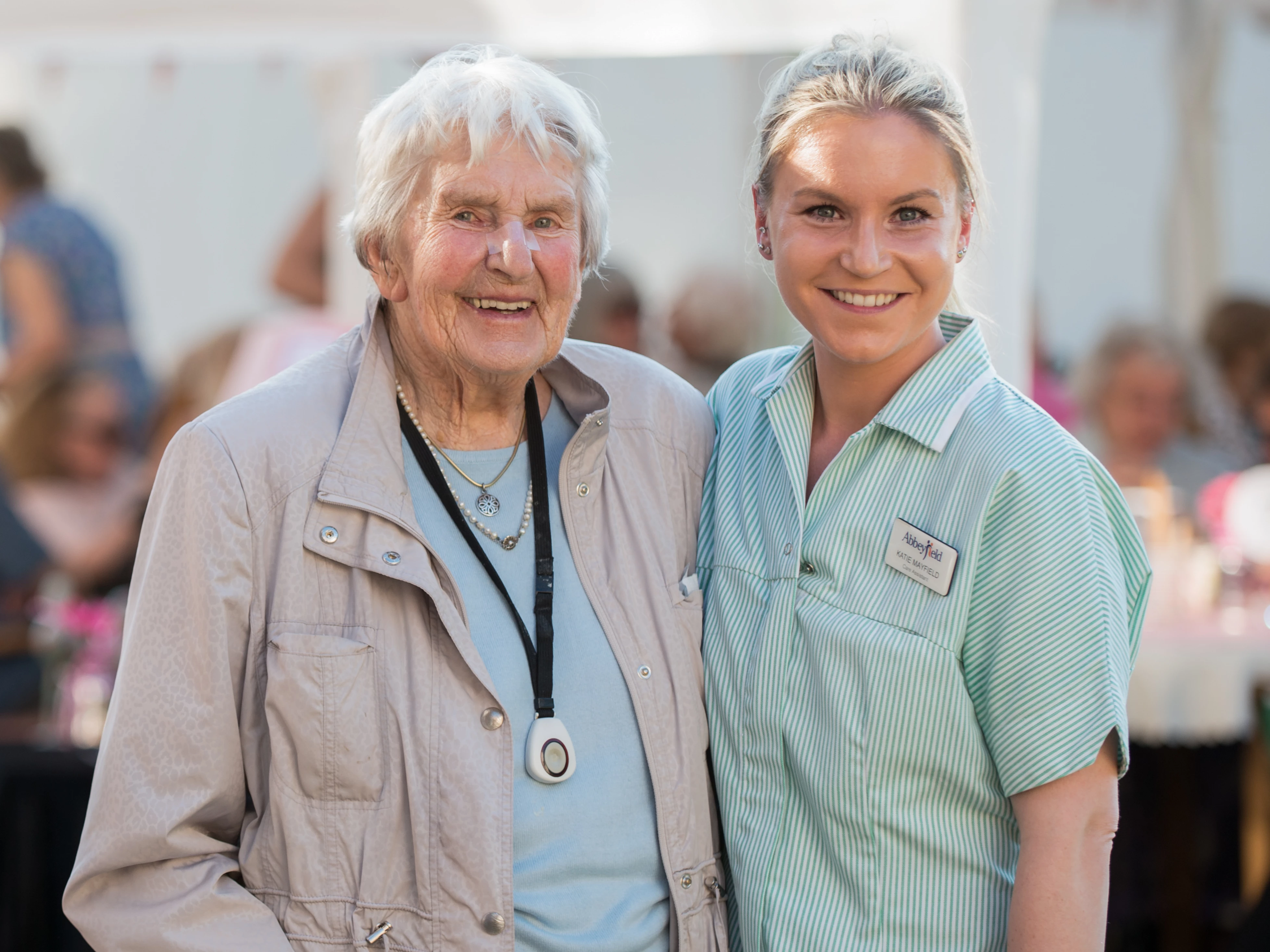 Resident And Carer Together At Garden Party