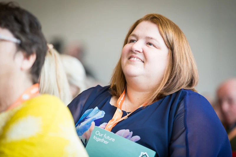 Member Of Staff Watching Presentation At Abbeyfield Conference