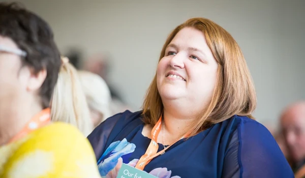 Member Of Staff Watching Presentation At Abbeyfield Conference
