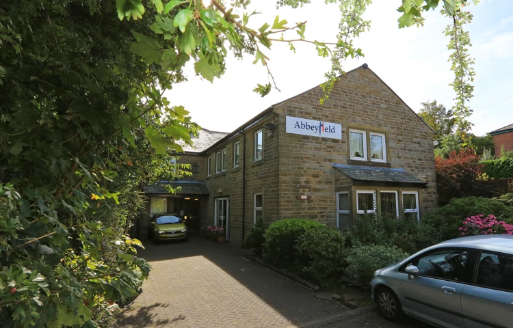 View of the entrance of Abbeyfield House with an Abbeyfield sign on the side