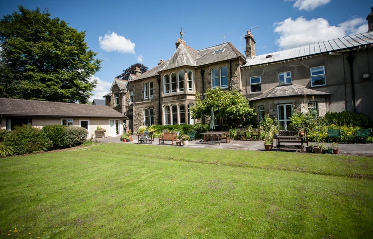 A bright lawn and seating area outside Cove House